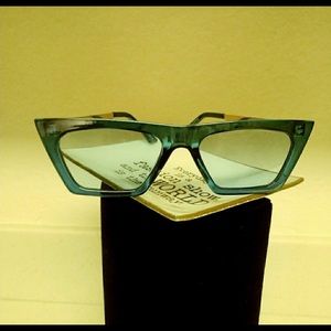 Structured edgy aqua blue framed glasses with blue lenses.